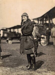 Leather-clad pilot (possibly Clarence M. Cutler) in front of his plane.