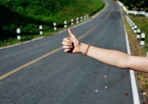 Hitchhiker thumb at side of road