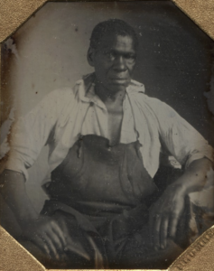 Portrait of Black man in leather apron