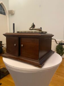Early flat disc record player in wood box