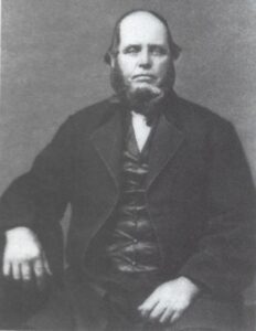 Portrait of heavyset man with beard in a suit