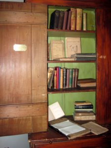 Bookshelf with three shelves and books on them