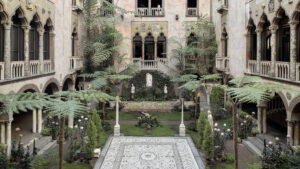 Courtyard with tile patio and trees enclosed by a building